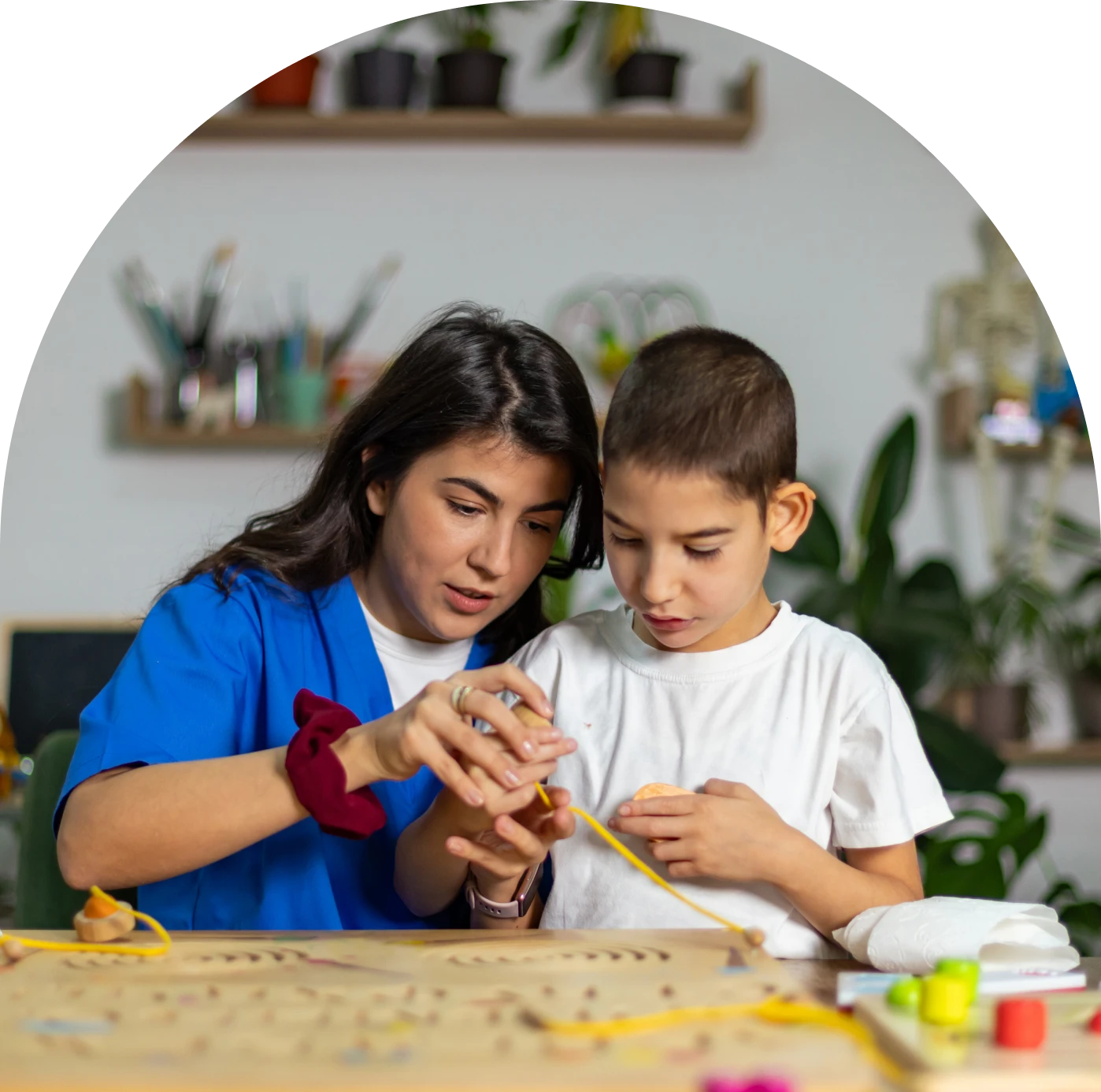 Woman guiding boy in art activity